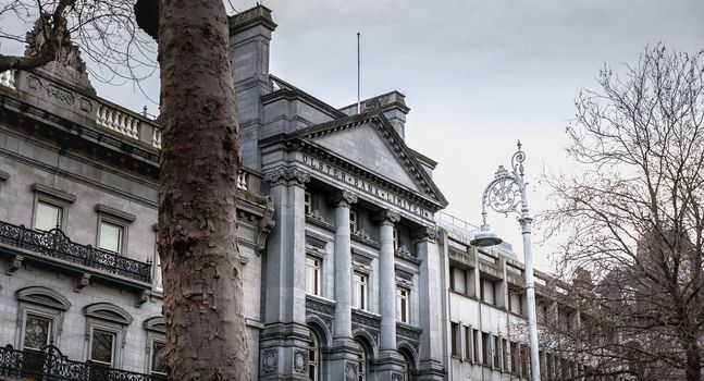 Dublin, Ireland - February 11, 2019: Architectural detail and street atmosphere in front of the Ulster Bank Commercial Bank building in the historic city center on a winter day