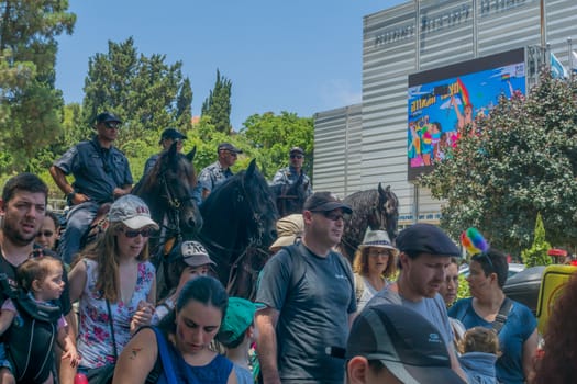 HAIFA, ISRAEL - JUNE 22, 2018: Various people take part, escorted by policemen on horses, in the annual pride parade of the LGBT community, in Haifa, Israel