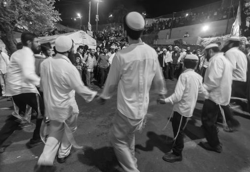 MERON, ISRAEL - MAY 18, 2014: Orthodox Jews dance at the annual hillulah of Rabbi Shimon Bar Yochai, in Meron, on Lag BaOmer Holiday. This is an annual celebration at the tomb of Rabbi Shimon