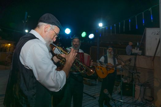 Safed, Israel - August 14, 2018: Scene of the Klezmer Festival, with street musicians playing, in Safed (Tzfat), Israel. Its the 31st annual traditional Jewish festival in the public streets of Safed