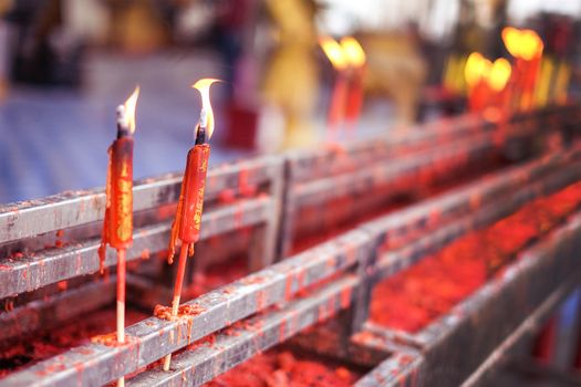 Burning red chinese candle in temple at Thailand
