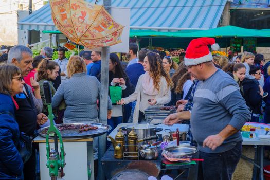 HAIFA, ISRAEL - DECEMBER 10, 2016: Market scene with sellers, shoppers and oriental sweets, as part of the holiday of holidays  events, in Haifa, Israel