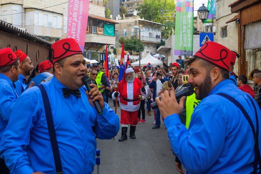 HAIFA, ISRAEL - DECEMBER 10, 2016: Scene of a Christmas parade, with local Arab Christians, and a crowd, as part of the holiday of holidays events, in Haifa, Israel