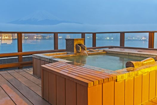 Japanese open air hot spa onsen with view of the mountain Fuji