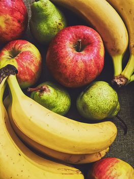 Organic apples, pears and bananas on rustic linen background, fruits farming and agriculture