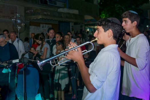 Safed, Israel - August 14, 2018: Scene of the Klezmer Festival, with street musicians and crowd. Safed (Tzfat), Israel. Its the 31st annual traditional Jewish festival in the public streets of Safed