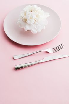 Dining plate and cutlery with peony flower as wedding decor set on pink background, top tableware for event decoration and dessert menu design