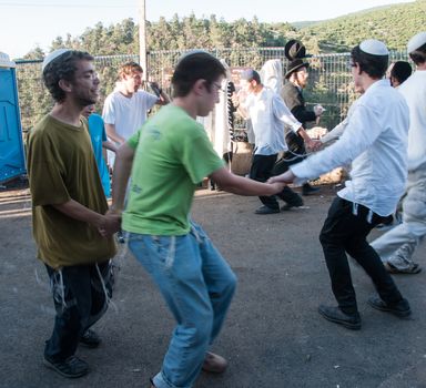 MERON, ISRAEL - MAY 18, 2014: Orthodox Jews dance at the annual hillulah of Rabbi Shimon Bar Yochai, in Meron, on Lag BaOmer Holiday. This is an annual celebration at the tomb of Rabbi Shimon