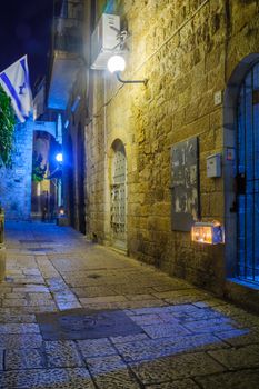 JERUSALEM, ISRAEL - DECEMBER 29, 2016: Alley with a display of Traditional Menorahs (Hanukkah Lamps) with olive oil candles, in the Jewish quarter, Jerusalem Old City, Israel