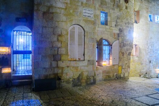 JERUSALEM, ISRAEL - DECEMBER 29, 2016: Alley with a display of Traditional Menorahs (Hanukkah Lamps) with olive oil candles, in the Jewish quarter, Jerusalem Old City, Israel