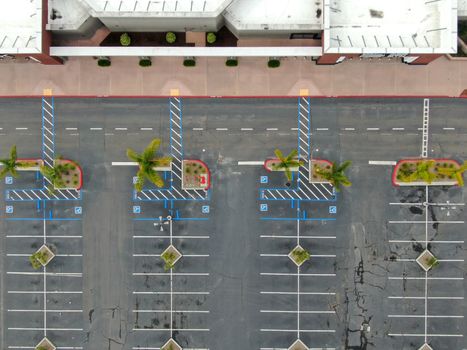 Aerial view of empty shopping center parking lot during COVID-19 pandemic.. Coronavirus virus and panic buying concept. San Diego, USA, March 22nd, 2020