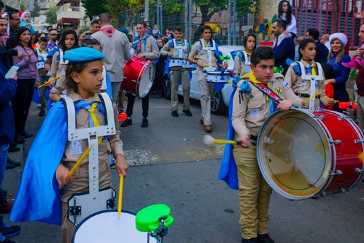 HAIFA, ISRAEL - DECEMBER 10, 2016: Scene of a Christmas parade, with local Arab Christians, and a crowd, as part of the holiday of holidays events, in Haifa, Israel