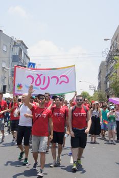 TEL-AVIV - JUNE 13, 2014: A group representing a gay youth club march in the Pride Parade in the streets of Tel-Aviv, Israel. The pride parade is an annual event of the gay community