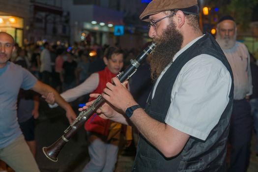 Safed, Israel - August 14, 2018: Scene of the Klezmer Festival, with street musician and crowd, in Safed (Tzfat), Israel. Its the 31st annual traditional Jewish festival in the public streets of Safed