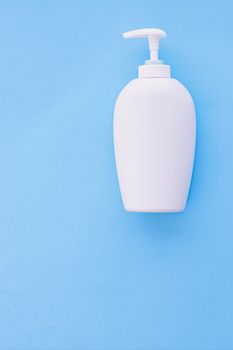 Blank label cosmetic container bottle as product mockup on blue background, hygiene and healthcare