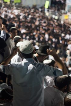 MERON, ISRAEL - MAY 18, 2014: An orthodox Jew raise his hands in dance at the annual hillulah (celebration) of Rabbi Shimon Bar Yochai, in Meron, on Lag BaOmer Holiday.