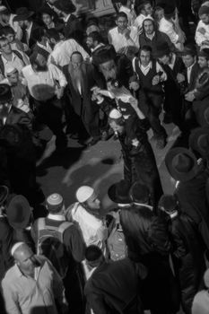 MERON, ISRAEL - MAY 18, 2014: Orthodox Jews dance at the annual hillulah of Rabbi Shimon Bar Yochai, in Meron, on Lag BaOmer Holiday. This is an annual celebration at the tomb of Rabbi Shimon