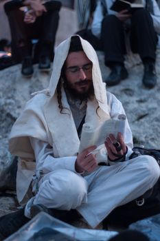 MERON, ISRAEL - MAY 18, 2014: Orthodox Jews prays a sunrise (Shacharit) pray at the annual hillulah (celebration) of Rabbi Shimon Bar Yochai, in Meron, on Lag BaOmer Holiday.