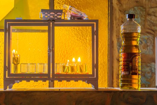 SAFED, ISRAEL - DECEMBER 26, 2016: Traditional Menorah (Hanukkah Lamp) with olive oil candles, placed near the door, in the Jewish quarter, in Safed (Tzfat), Israel