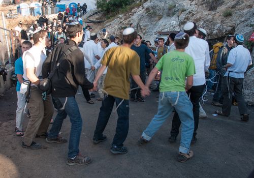 MERON, ISRAEL - MAY 18, 2014: Orthodox Jews dance at the annual hillulah of Rabbi Shimon Bar Yochai, in Meron, on Lag BaOmer Holiday. This is an annual celebration at the tomb of Rabbi Shimon