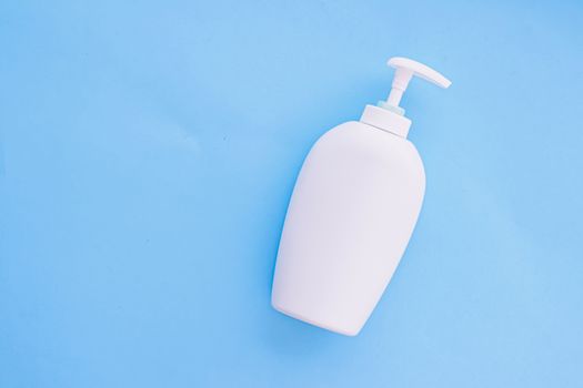 Blank label cosmetic container bottle as product mockup on blue background, hygiene and healthcare