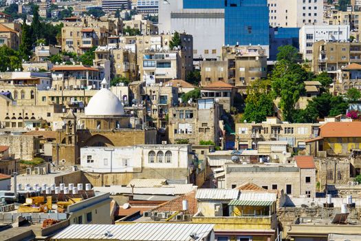 HAIFA, ISRAEL - JULY 21, 2015: Rooftop view of downtown, with religious and commercial buildings from various periods, in Haifa, Israel