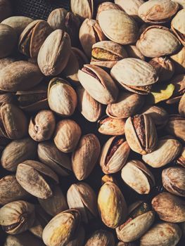 Pistachio nuts on rustic linen background, food and nutrition