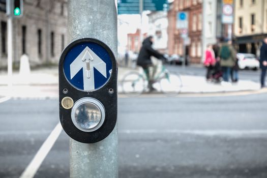 button to activate pedestrian crossing on the road on a pedestrian crossing in the city center on a winter day