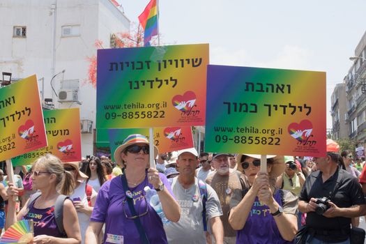 TEL-AVIV - JUNE 13, 2014: A group of parents march in the Pride Parade in the streets of Tel-Aviv, Israel. The pride parade is an annual event of the gay community