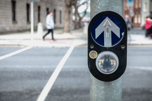 button to activate pedestrian crossing on the road on a pedestrian crossing in the city center on a winter day