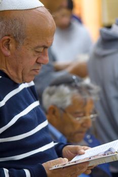 NETIVOT, ISRAEL - JANUARY 30, 2017: Jewish men pray at the Rabbi Israel Abuhatzeira (Baba Sali) tomb, as part of the annual hillula of his memory. In Netivot, Israel