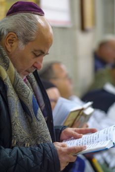 NETIVOT, ISRAEL - JANUARY 30, 2017: Jewish men pray at the Rabbi Israel Abuhatzeira (Baba Sali) tomb, as part of the annual hillula of his memory. In Netivot, Israel