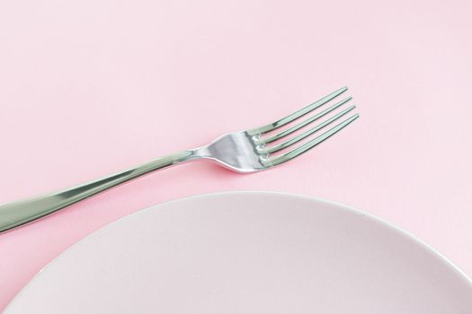 Empty plate and cutlery as mockup set on pink background, top tableware for chef table decor and menu branding design