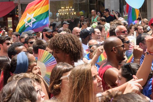 TEL-AVIV - JUNE 13, 2014: A crowd of people march in the Pride Parade in the streets of Tel-Aviv, Israel. The pride parade is an annual event of the gay community
