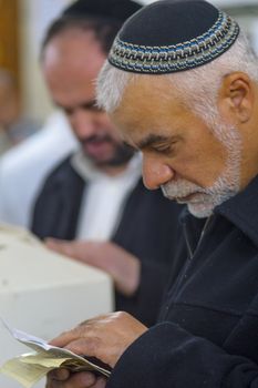 NETIVOT, ISRAEL - JANUARY 30, 2017: Jewish men pray at the Rabbi Israel Abuhatzeira (Baba Sali) tomb, as part of the annual hillula of his memory. In Netivot, Israel