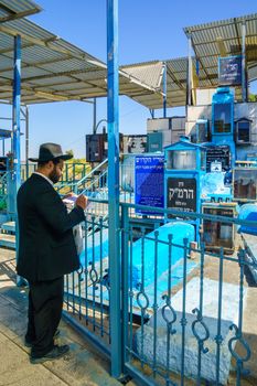 SAFED, ISRAEL - SEPTEMBER 18, 2015: Jewish man prays at the tomb of The ARI (Rabbi Isaac Luria), in Safed, Israel