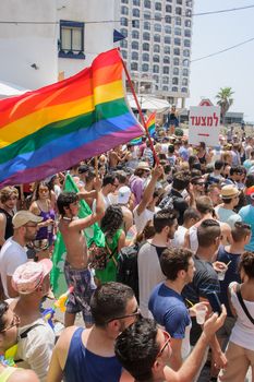 TEL-AVIV - JUNE 13, 2014: A crowd of people march in the Pride Parade in the streets of Tel-Aviv, Israel. The pride parade is an annual event of the gay community