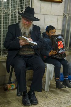 NETIVOT, ISRAEL - JANUARY 30, 2017: Jewish men pray at the Rabbi Israel Abuhatzeira (Baba Sali) tomb, as part of the annual hillula of his memory. In Netivot, Israel