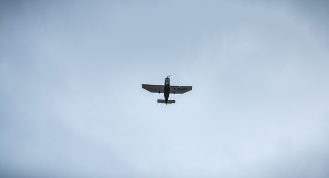 Port Joinville, France - September 16, 2018: Small passenger plane flying over Isle of Yeu near France on a fall day