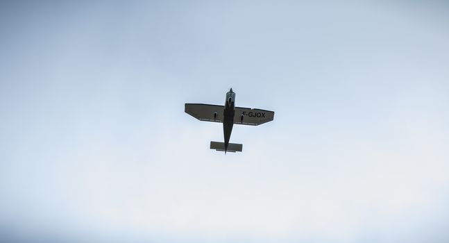 Port Joinville, France - September 16, 2018: Small passenger plane flying over Isle of Yeu near France on a fall day