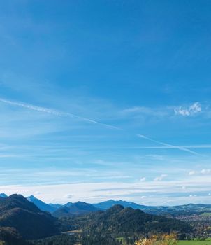 Beautiful nature of European Alps, landscape view of alpine mountains, lake and village on a sunny day, travel and destination scenery