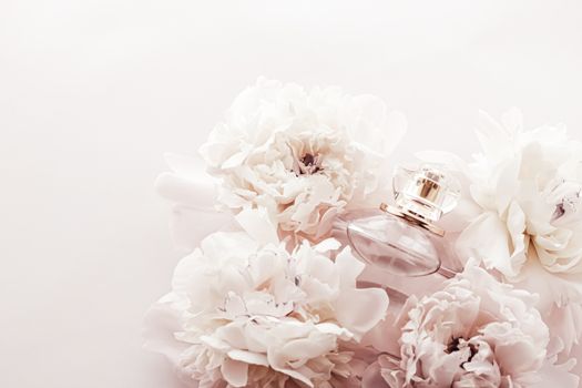 Fragrance bottle as luxury perfume product on background of peony flowers, parfum ad and beauty branding design