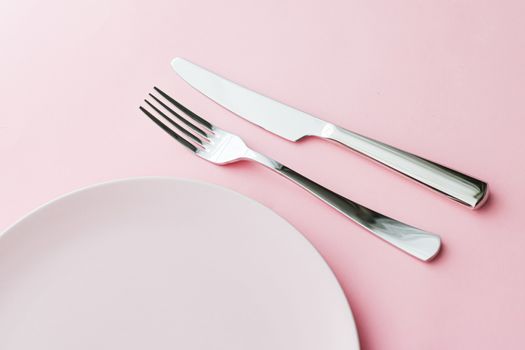 Empty plate and cutlery as mockup set on pink background, top tableware for chef table decor and menu branding design