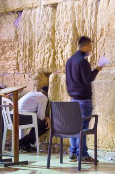 JERUSALEM, ISRAEL - SEPTEMBER 21, 2015: Jewish men pray Selichot (Jewish penitential prays) in the western wall, in the old city of Jerusalem, Israel