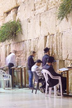 JERUSALEM, ISRAEL - SEPTEMBER 21, 2015: Jewish men pray Selichot (Jewish penitential prays) in the western wall, in the old city of Jerusalem, Israel