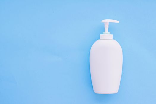 Blank label cosmetic container bottle as product mockup on blue background, hygiene and healthcare