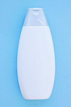 Blank label cosmetic container bottle as product mockup on blue background, hygiene and healthcare