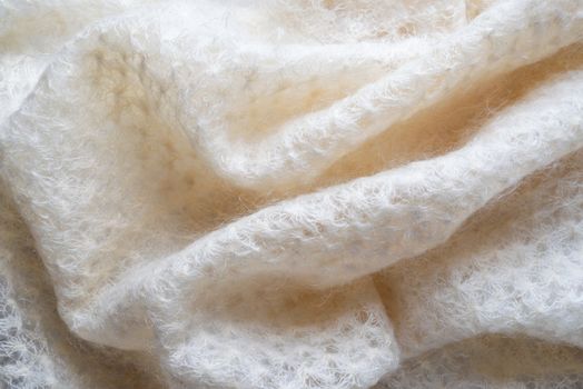 Soft folds of a white goat fluff scarf to be used as background