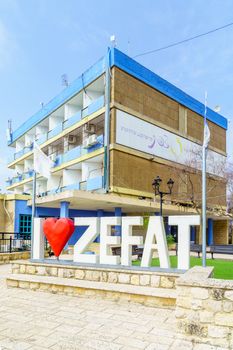 Safed, Israel - March 10, 2020: View of an I love Zefat sign, and the city hall building in Safed (Tzfat or Zefat), Israel