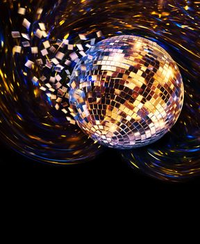 Vintage disco mirror ball spinning and breaking into blue and golden flying glass fragments on dark background